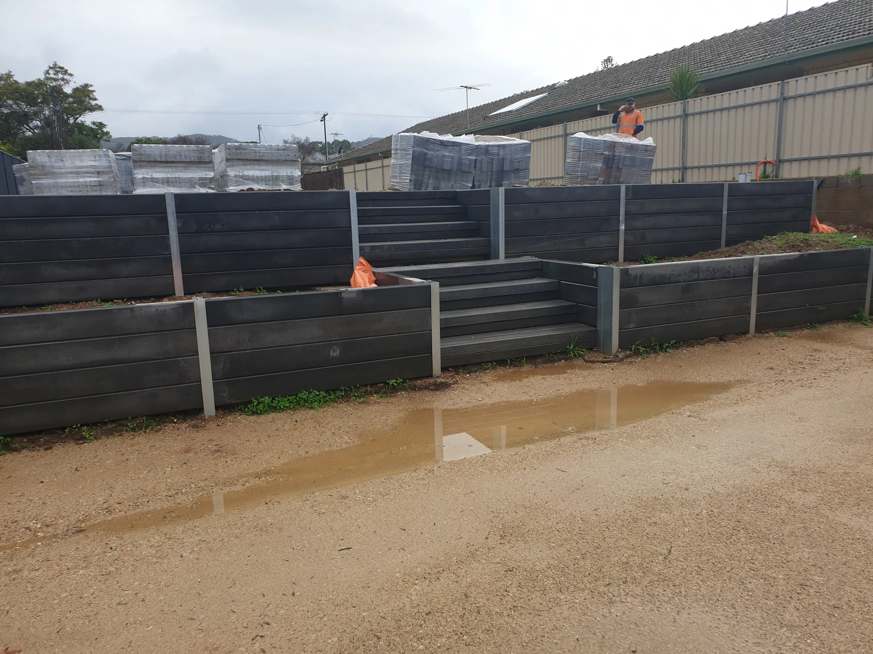 Tiered retaining wall with engineered footings
