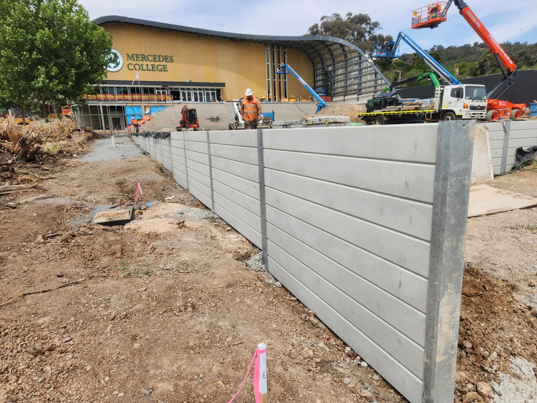 Completed sleeper retaining wall along a residential boundary