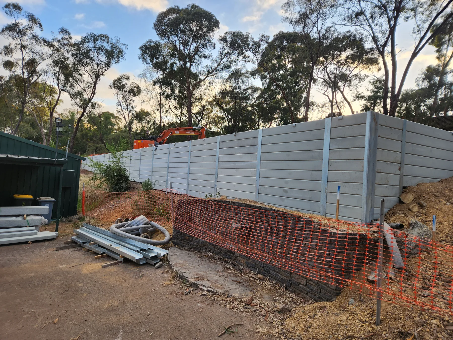 Long retaining wall securing a residential block at sunrise
