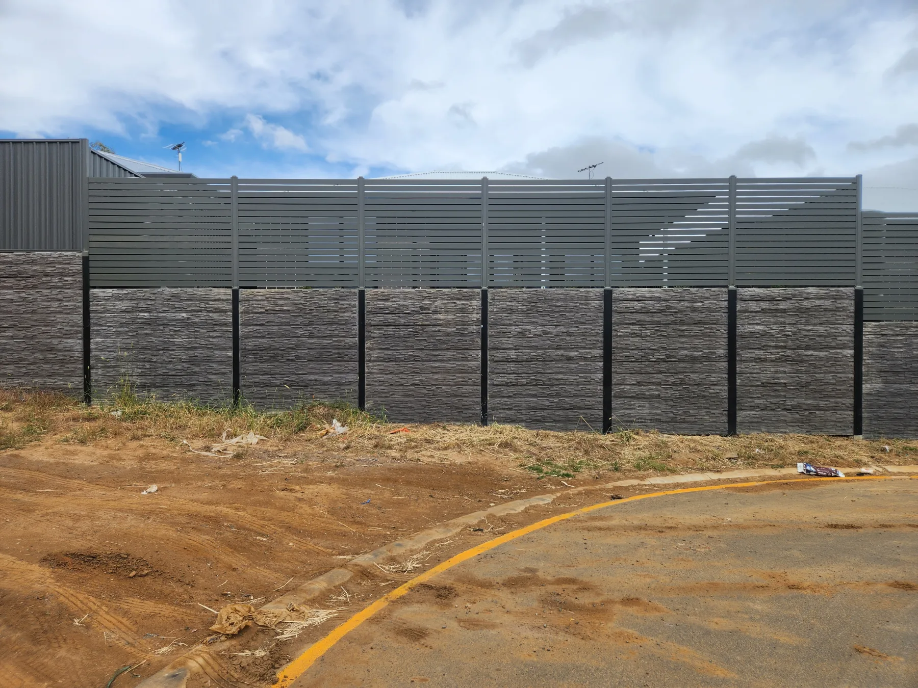 Hardwood retaining wall built along a steep driveway